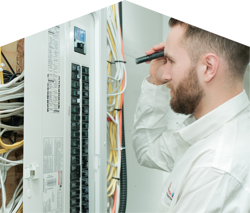 Mersey electrician inspecting residential electrical panel wiring with a flashlight, checking connections and circuit labels. Mersey electrician inspecting residential electrical panel wiring with a flashlight, checking connections and circuit labels.
