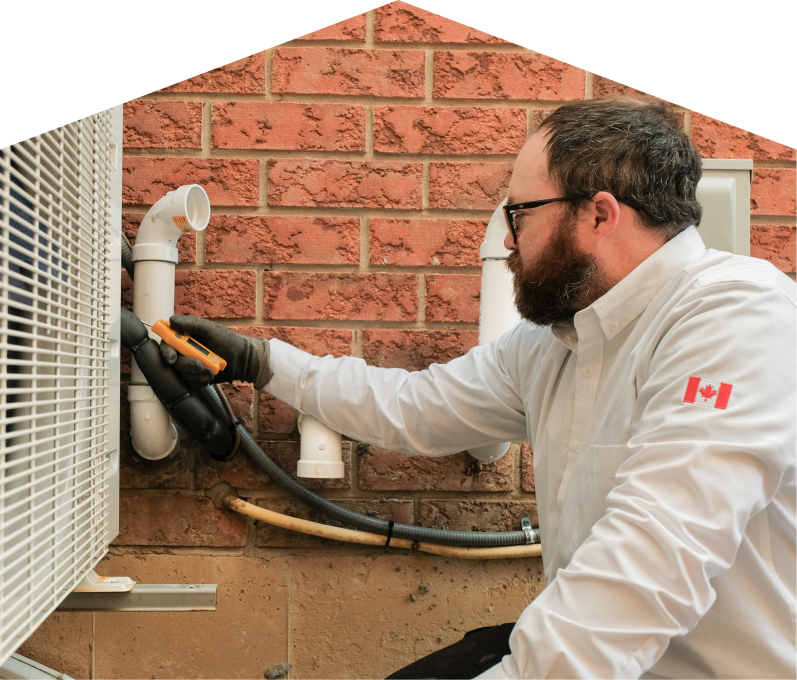 Mersey HVAC specialist checking insulated piping on a heat pump unit beside a brick wall during a diagnostic service. Mersey HVAC specialist checking insulated piping on a heat pump unit beside a brick wall during a diagnostic service.