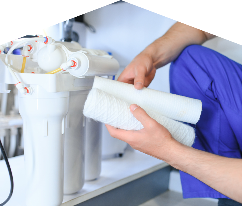 Mersey water filtration specialist replacing filter cartridges on a reverse osmosis water system installed under a sink. Mersey water filtration specialist replacing filter cartridges on a reverse osmosis water system installed under a sink.