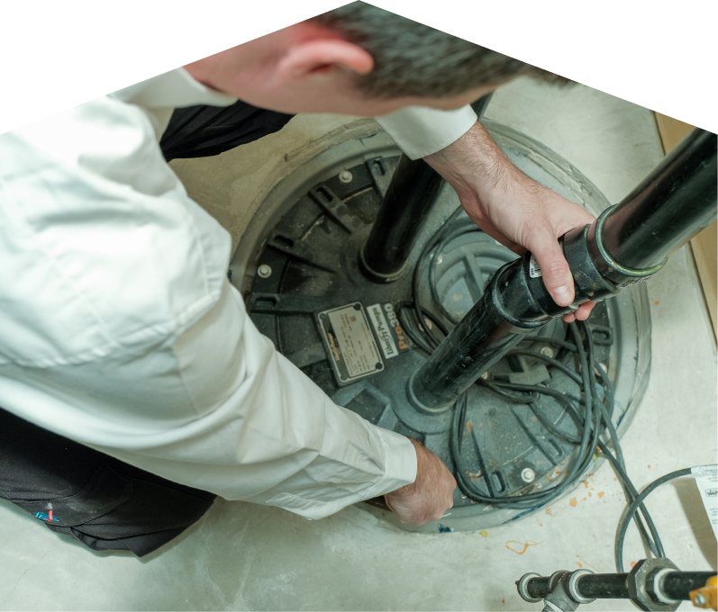 Mersey sump pump specialist secures discharge piping on a sealed basin during a sump pump installation in a basement utility area. Mersey sump pump specialist secures discharge piping on a sealed basin during a sump pump installation in a basement utility area.