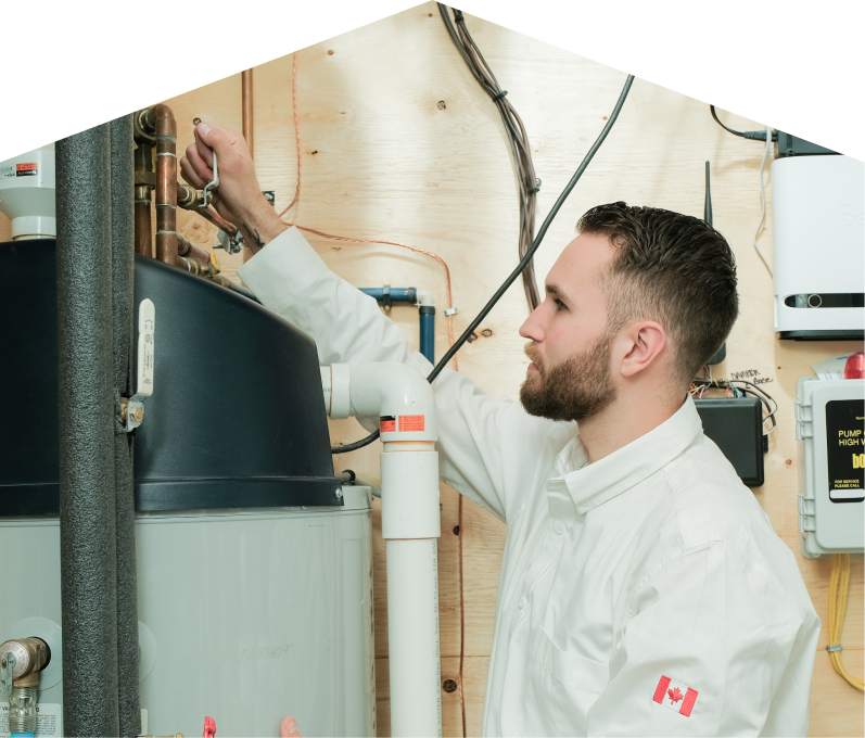 Mersey water heater specialist adjusts piping on a large residential unit during a repair service, with exposed wood paneling and mounted utility components in the background. Mersey water heater specialist adjusts piping on a large residential unit during a repair service, with exposed wood paneling and mounted utility components in the background.