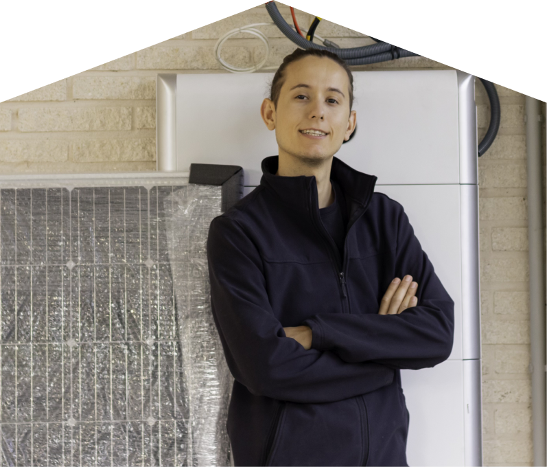 Mersey specialist standing confidently with arms crossed beside newly delivered system components, including a wrapped panel and wall-mounted utility unit. Mersey specialist standing confidently with arms crossed beside newly delivered system components, including a wrapped panel and wall-mounted utility unit.
